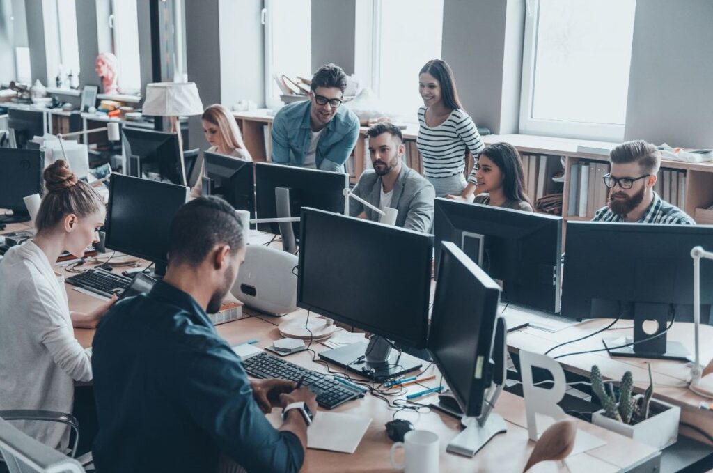 Support team working on computers in an office