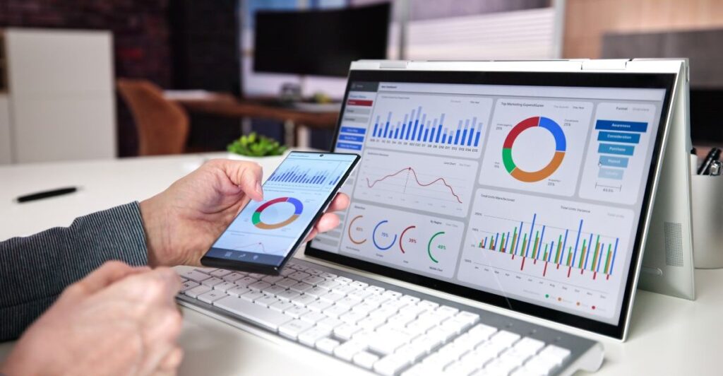 IT infrastructure dashboards displayed on laptop and mobile device