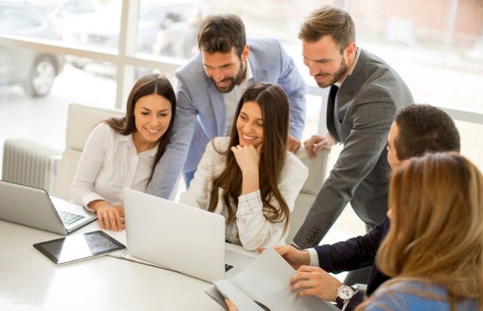 A group of business consultants discussing digital transformation solutions through a Microsoft Partnership.